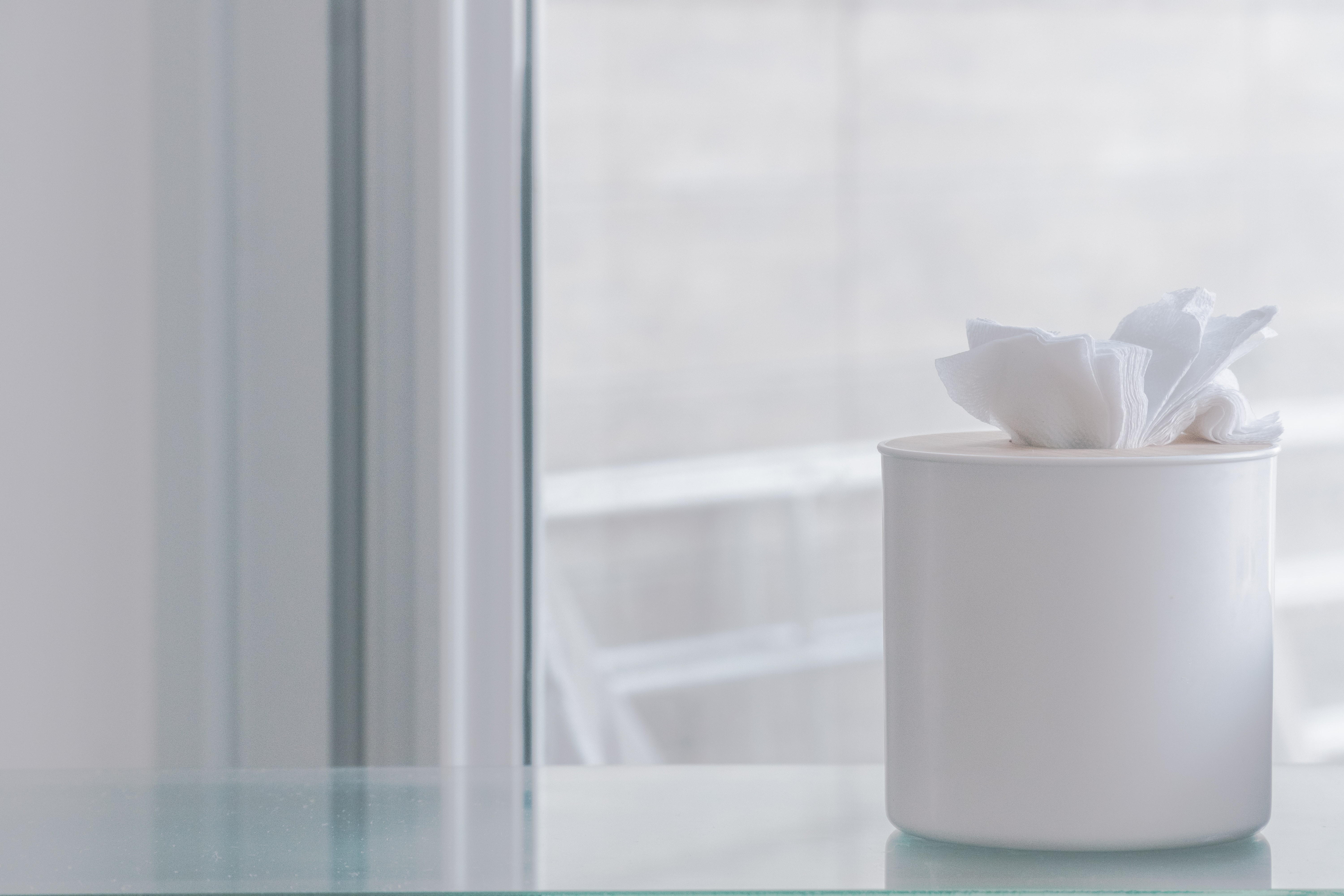 photo of a window with a box of tissues beside it